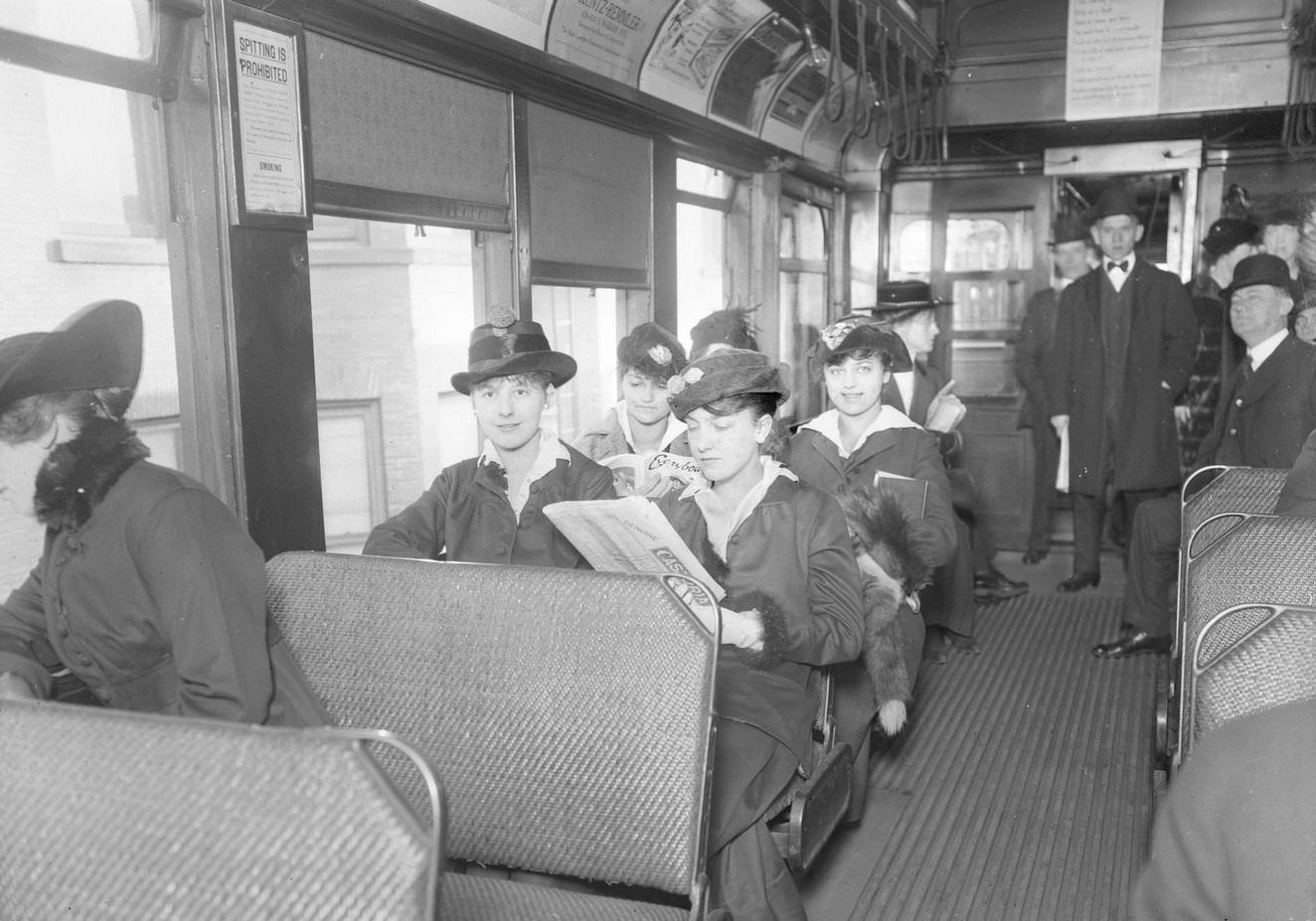 #39 Passengers sitting on an open window elevated train car on the Jackson Park branch in Chicago, Illinois, 1910s.