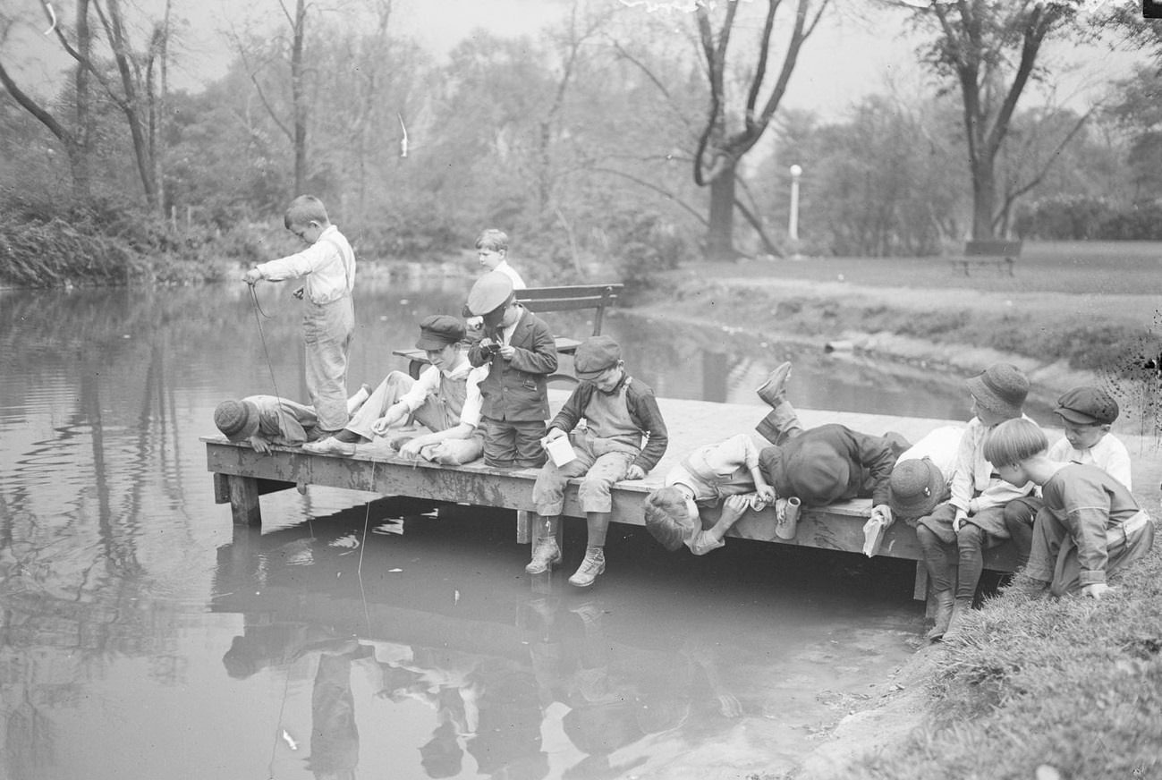 #28 Young boys playing and fishing from a dock in Lincoln Park, Chicago, Illinois, 1919.