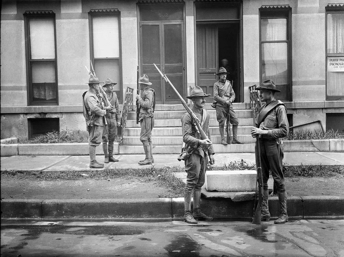 #29 Armed National Guard standing outside apartments during the race riots in Chicago, Illinois, 1919.