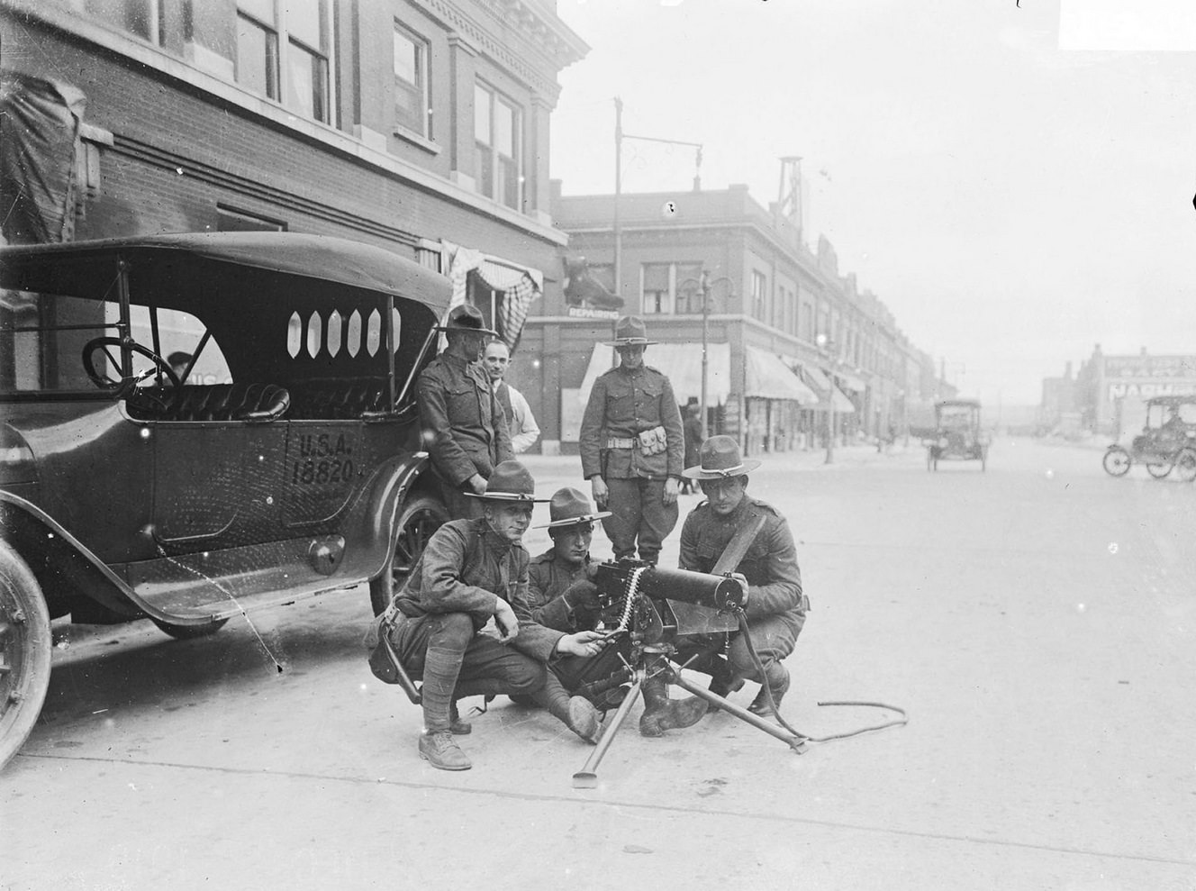#53 Strike at U.S. Steel Corporation, Gary, Indiana, with three military men squatting around machine gun, Chicago, Illinois, 1919.