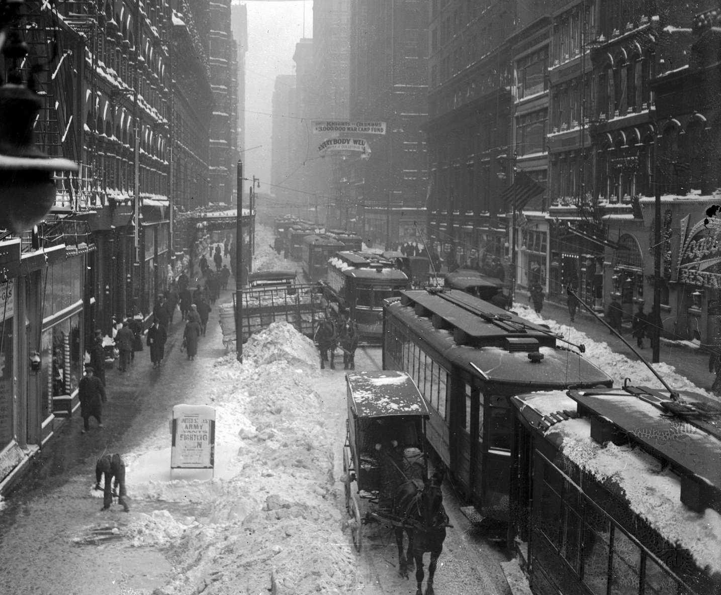 #17 West Madison Street looking from North Wells Street, with Vogelsang’s Restaurant at 173-181 West Madison visible on the extreme right, during a snowstorm in the Loop community, Chicago, Illinois, 1918.