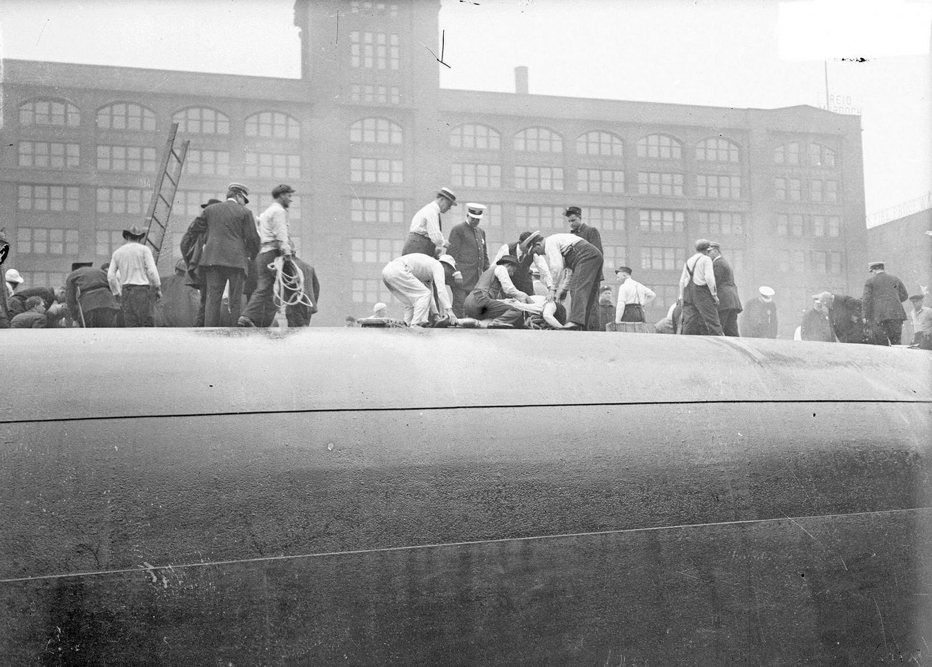 #93 Rescuers and survivors atop the hull of the overturned Eastland steamer in the Chicago River, Chicago, Illinois, circa July 24, 1915.