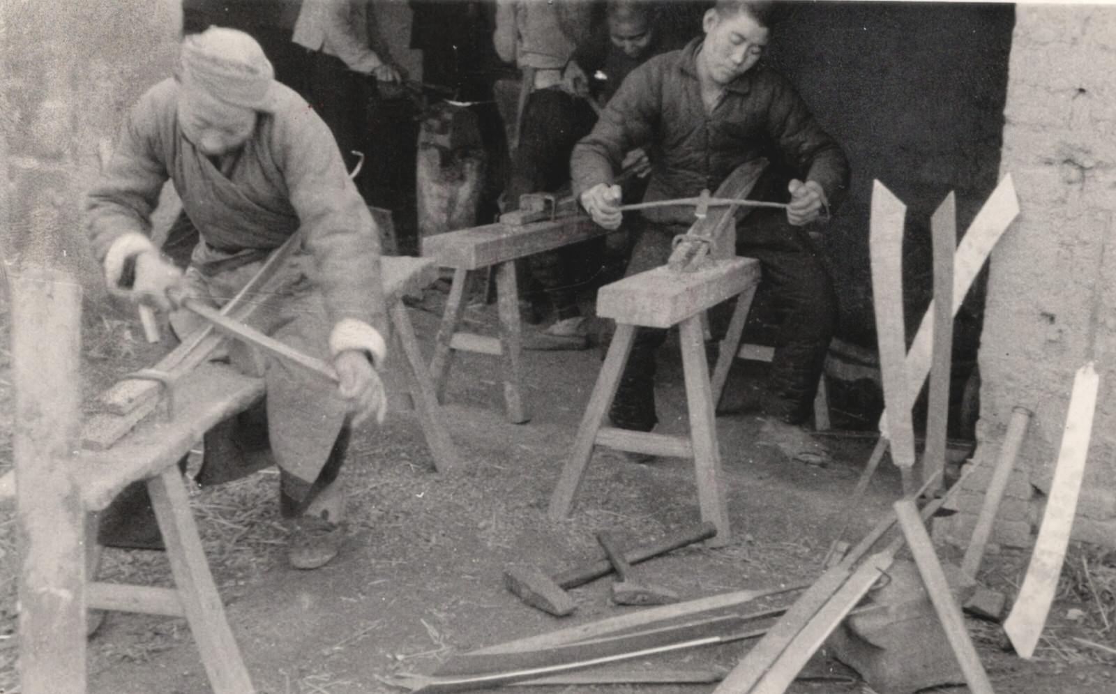 #112 Railway workers on the Peking-Hankow (Beijing-Hankou) railway tore up steel railways and girders and made big swords for the guerrillas and the army from them. 1937-1940