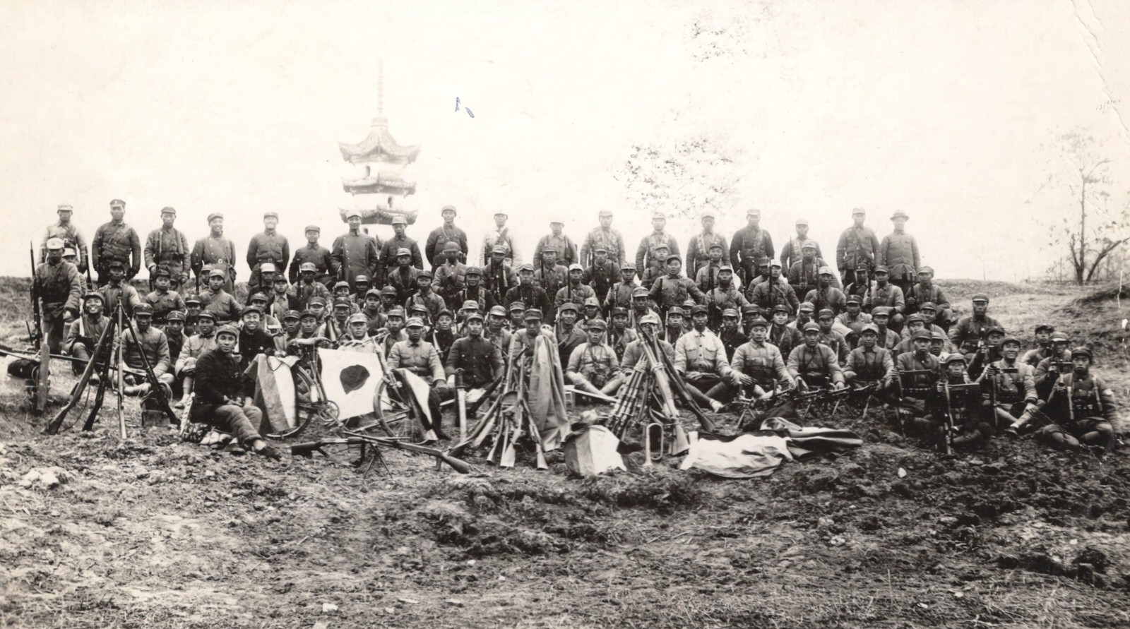 #120 Communist-led New Fourth Army after a raid made by this detachment on a Japanese air-drome. Note the trophies of guns, bicycles, flags and coats. 1937-1940