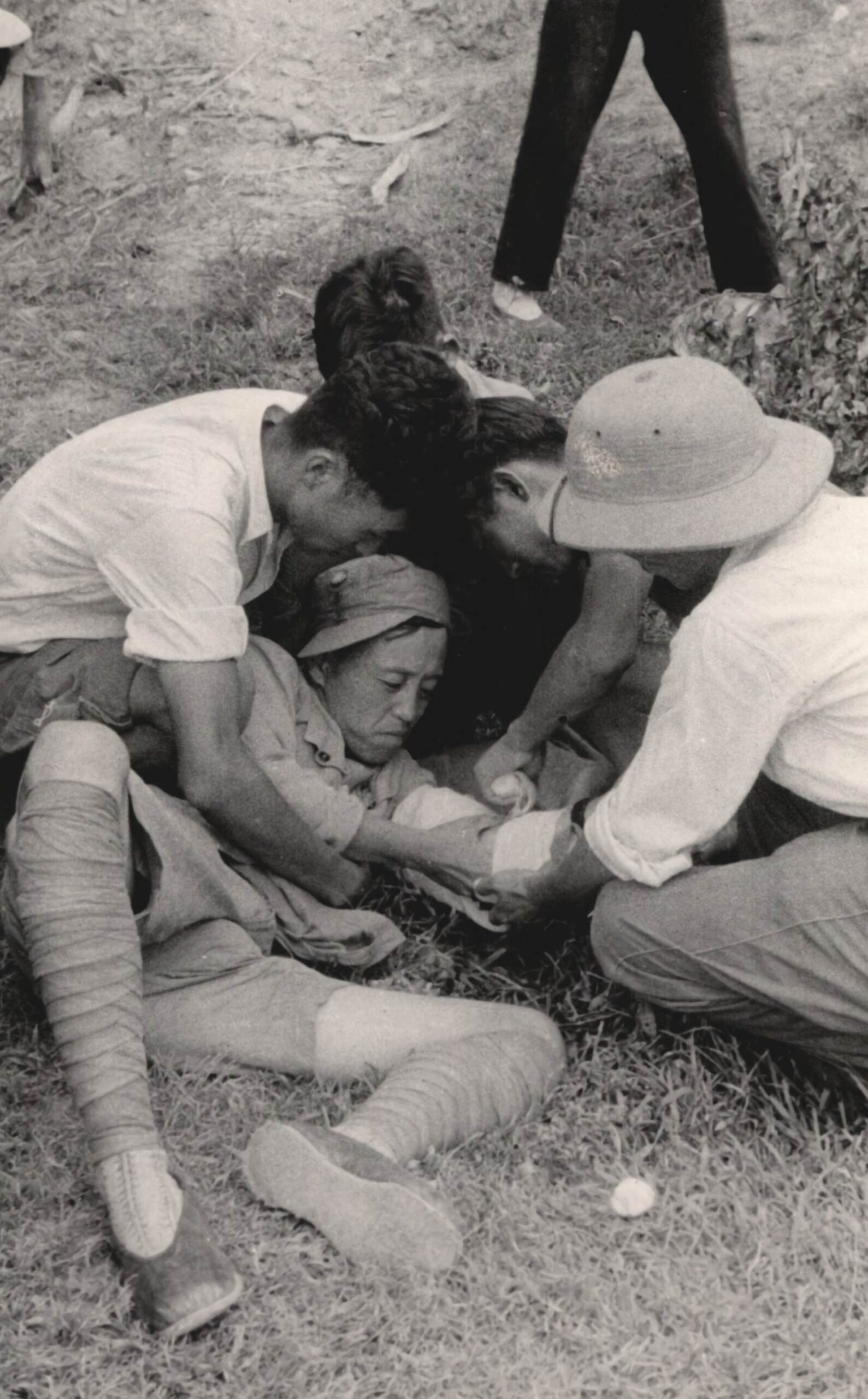 #140 In the center is a doctor of the New Fourth Army, wounded, whose dressing is being changed. 1937-1940