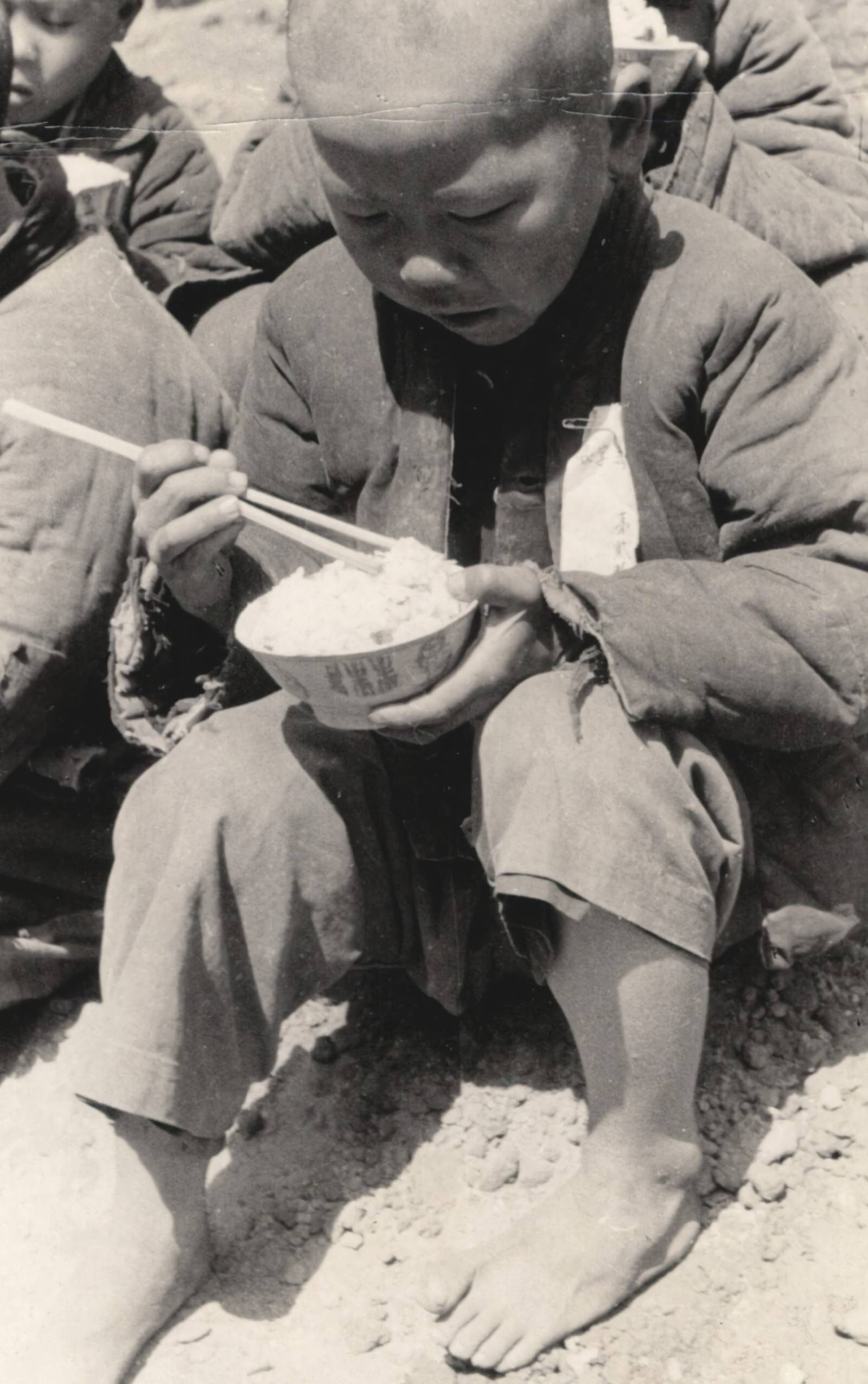 #153 After the war-orphans had been dressed in clean new uniforms and had been bathed and shaved, they began their first regular meals. 1937-1940