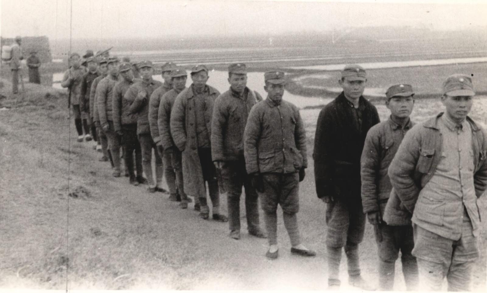 #66 A column of Chinese puppet soldiers who fought for the Japanese. Captured by the New Fourth Army Storm Guerrilla Detachment in battle. These men were either conscripted or captured and put in the Japanese puppet forces.1937-1940