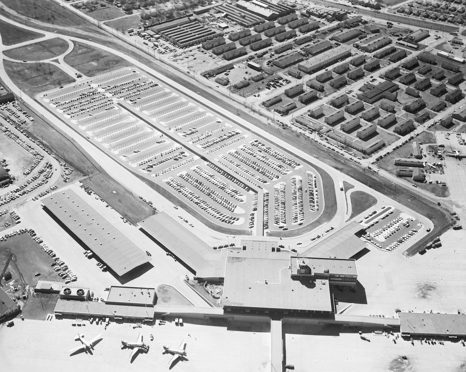 #10 Aerial view of Dallas Love Field Administration Building featuring parking area, 1950s