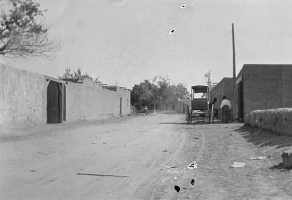 #33 Road with adobe buildings and carriage, 1907