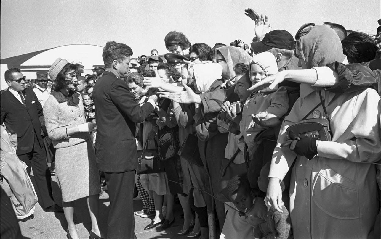 #111 President John F. Kennedy and Jackie shaking hands in crowd just before leaving Carswell Air Force Bas , Fort Worth, 1963
