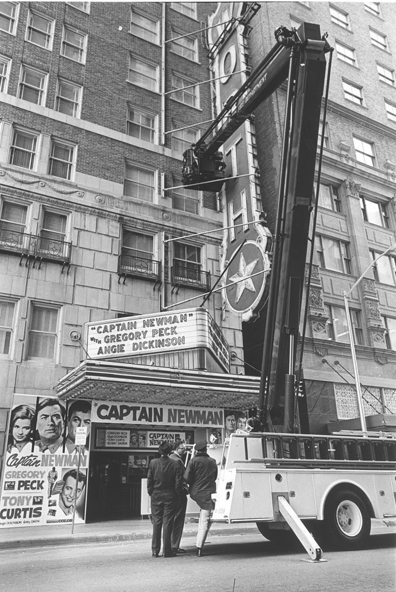 #20 Fire truck adjusts Worth Theater sign, 1964