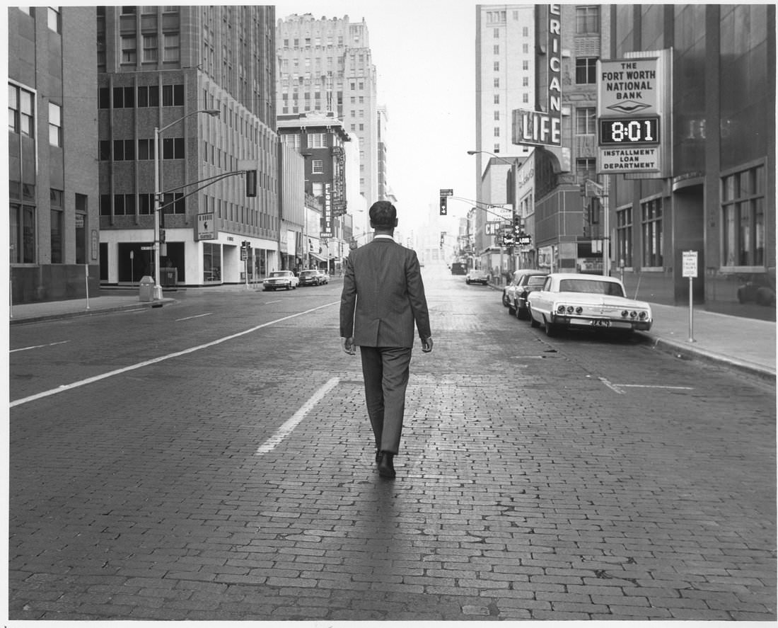 #8 Main St. between 7th and 8th Streets showing Fort Worth National Bank sign and man walking down middle of street, 1960s