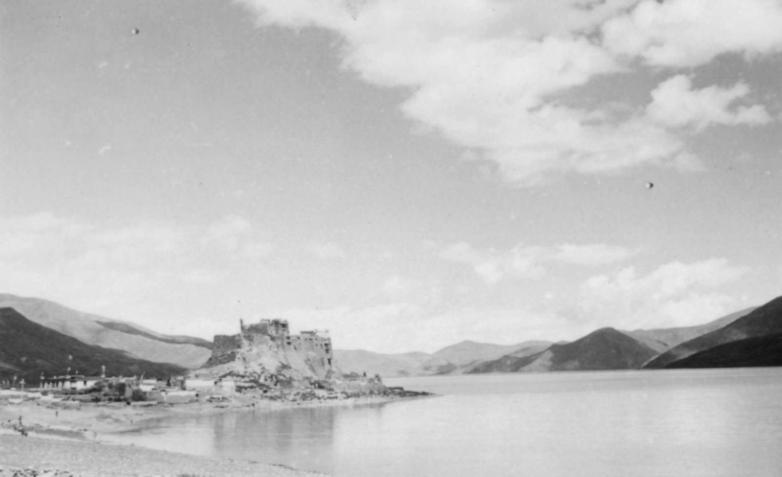 #21 The Yamdrok Lake, 1944. The Yamdrok Lake (more than 14,000 feet above sea level), with the castled town of Pedi on its shore.