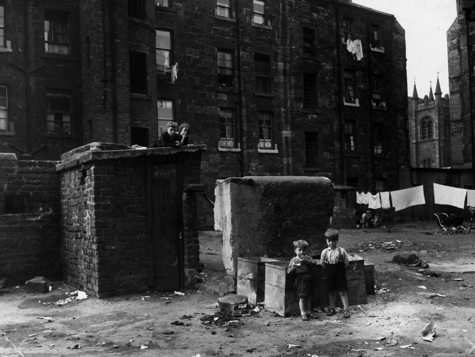 #25 Children playing in a Glasgow slum which is to be demolished, 1956