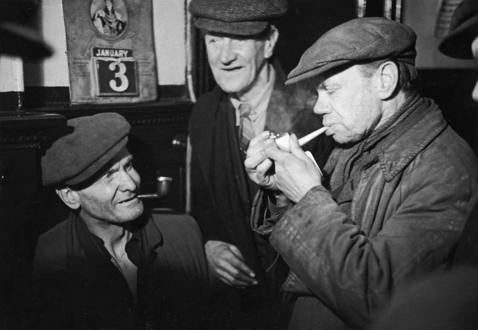 #43 Men from the Gorbals, Glasgow’s slum area, meet in the local pub for a friendly smoke, 3rd January 1948.