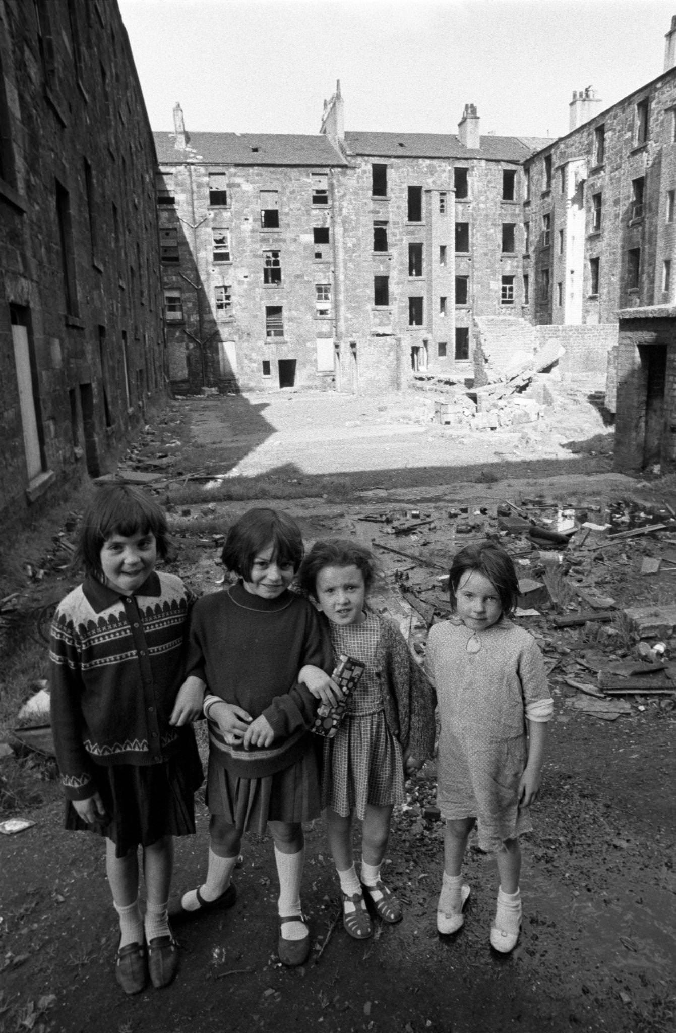 #58 Four little girls posing in front of slum housing in the notorious Gorbals district of Glasgow in 1969.