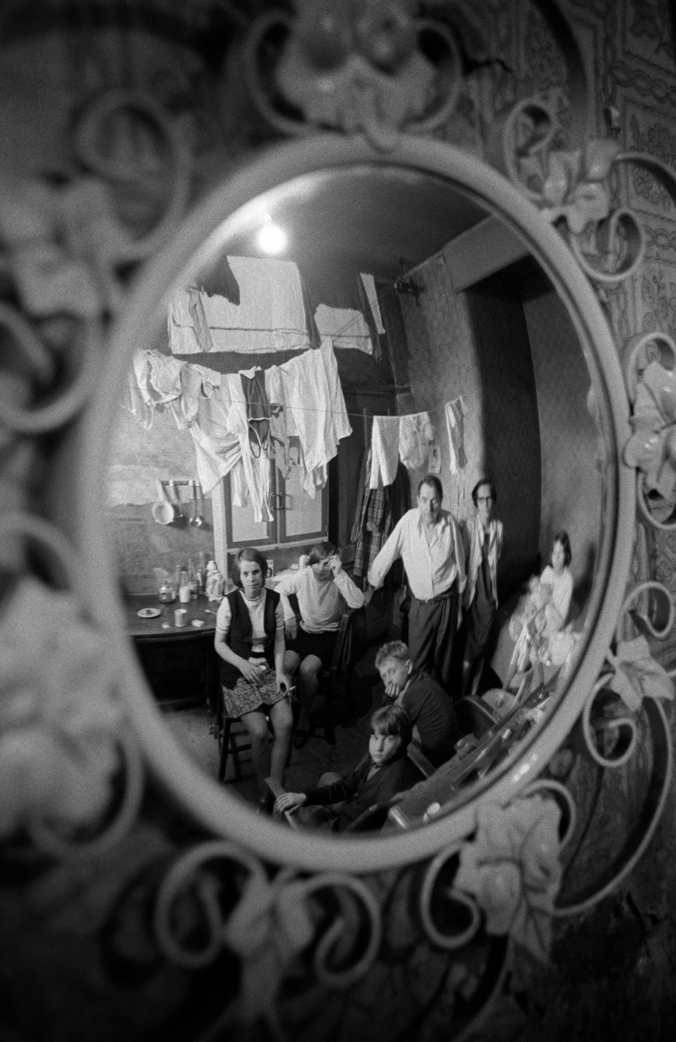 #61 A family of eight reflected in a mirror in their home in the notorious Gorbals district of Glasgow in 1969.