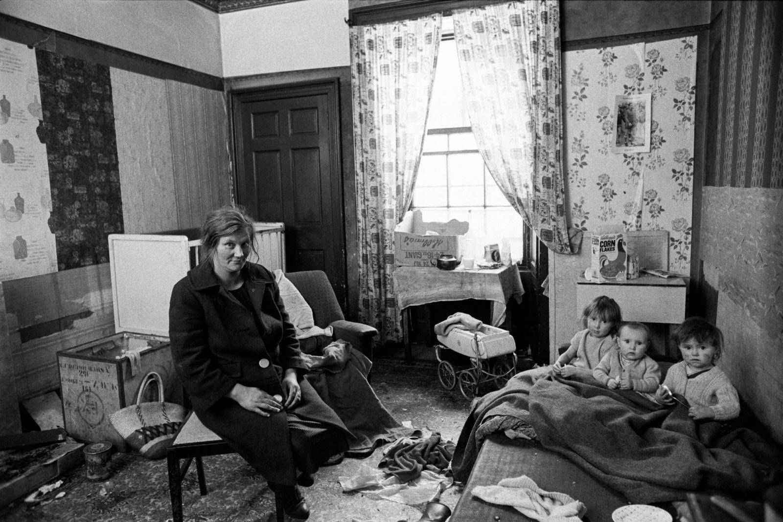 #67 A mother and three little children in the interior of their flat in the notorious Gorbals district of Glasgow, 1969.