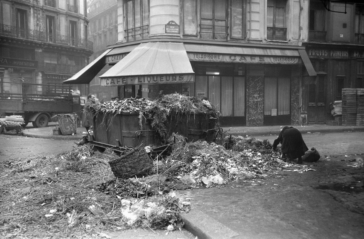 #106 A street of the Les Halles district in Paris littered with garbage during the city binmen’s strike, 1947
