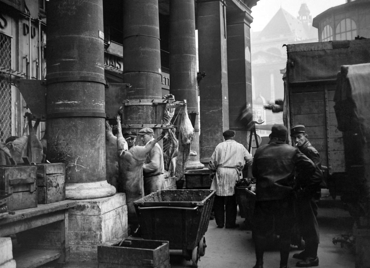 #127 Butchers work at les Halles district in January 1946 in Paris, while rationing measures are still in force in France.