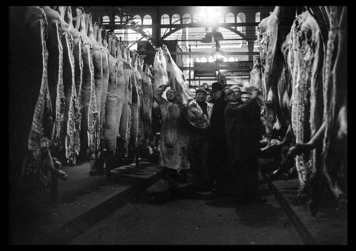#128 Butchers work at les Halles district in January 1946 in Paris, while rationing measures are still in force in France.