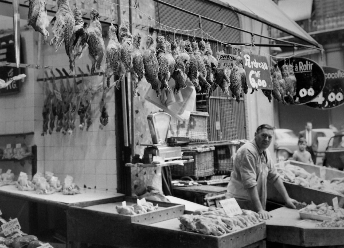 #1 After the opening of the hunt, game is sold by a butcher in a stall in Les Halles on September 6, 1960
