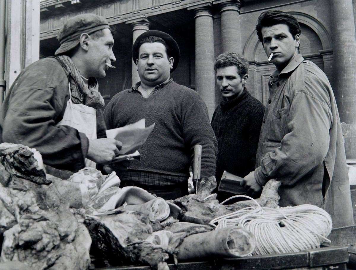 #56 Butcher at Les Halles in front of church St. Eustache, Les Halles, 1964