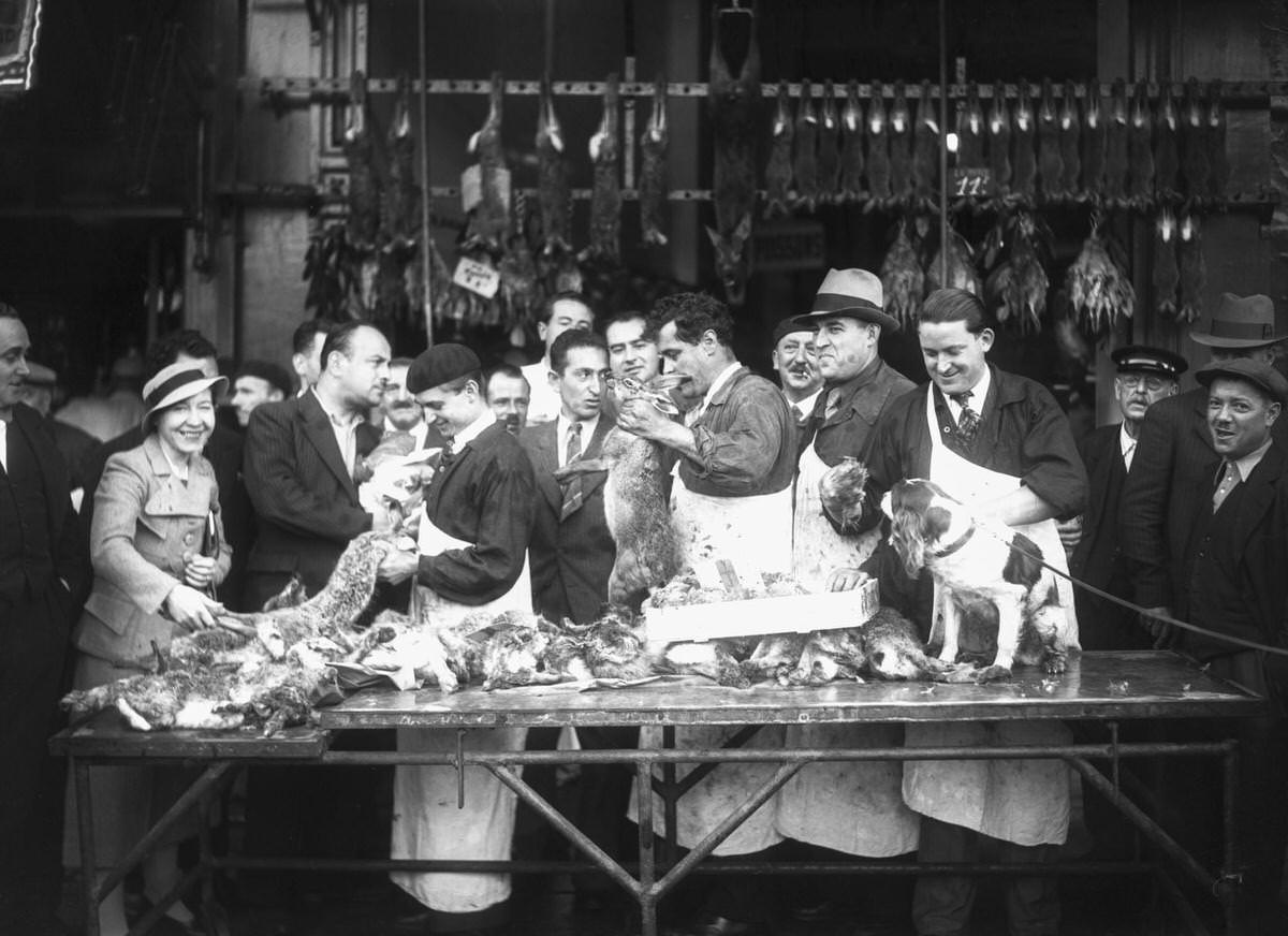 #27 Customers buying game in a store in Les Halles, Paris, 1936