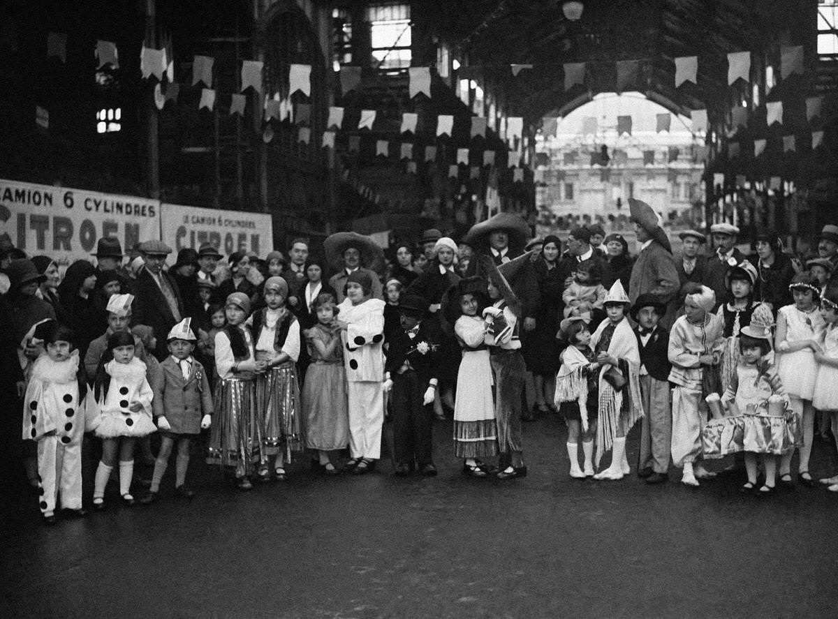 #49 Children in disguise at the Lily of the Valley festival organized by the ‘Forts des halles’ in the halls of Paris, 1930.