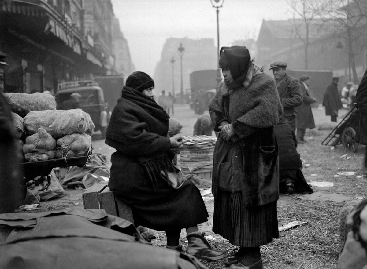 #57 Women freezing during the season of winter, in the street of the Les Halles district, 1930s