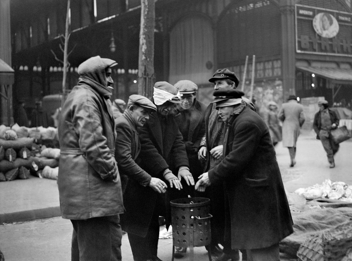 #58 Men warming up around a brazier, during the season of winter, in the street of the Les Halles district, 1930s