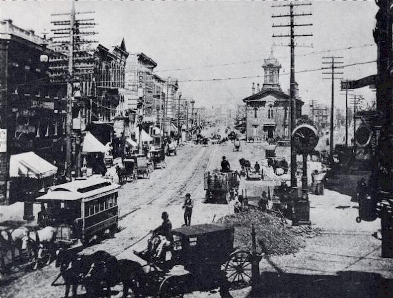 #12 Section of the factory at a crossroads with road construction workers outside, 1890