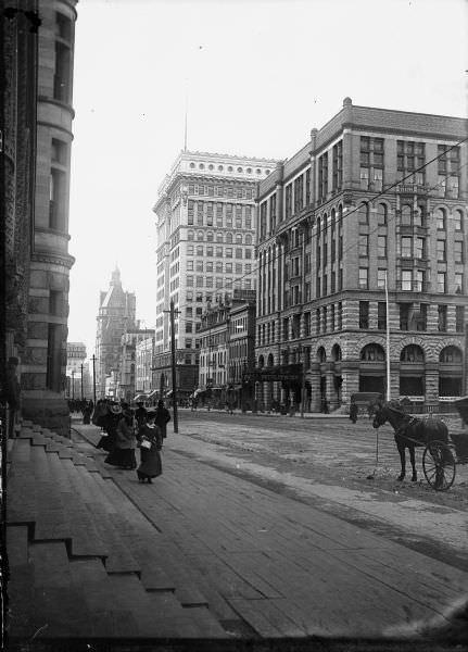 #53 East Wisconsin Avenue showing men and women on the sidewalks and the Hotel Pfister in the background, 1893