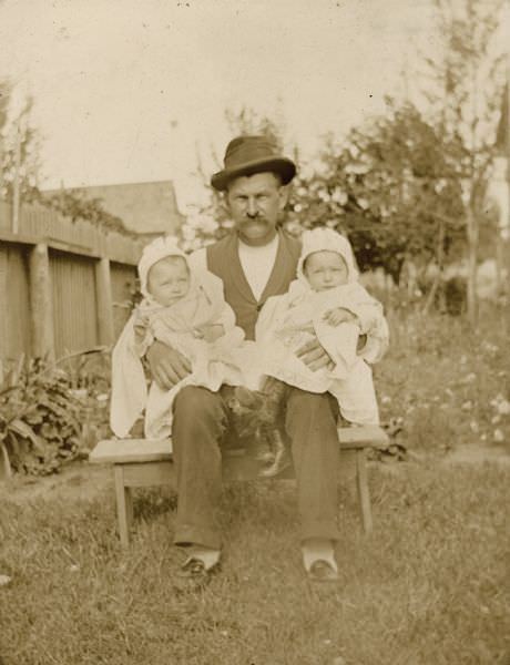 #63 Gustav Willms holding his twin daughters, 1894