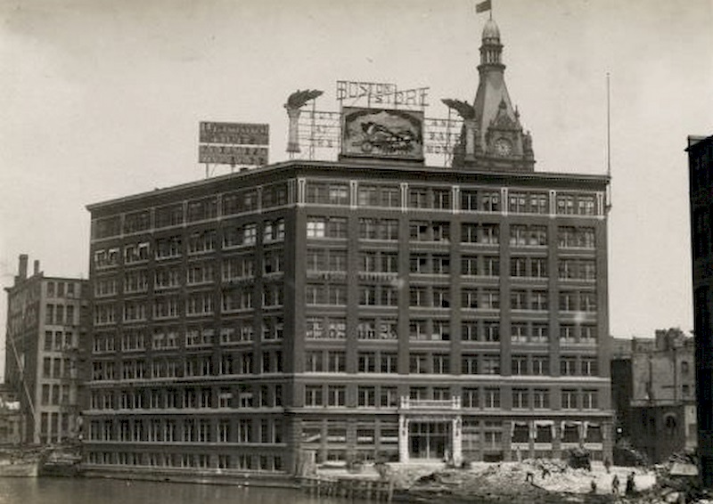 #70 Building from across the river, with construction workers working nearby, 1895