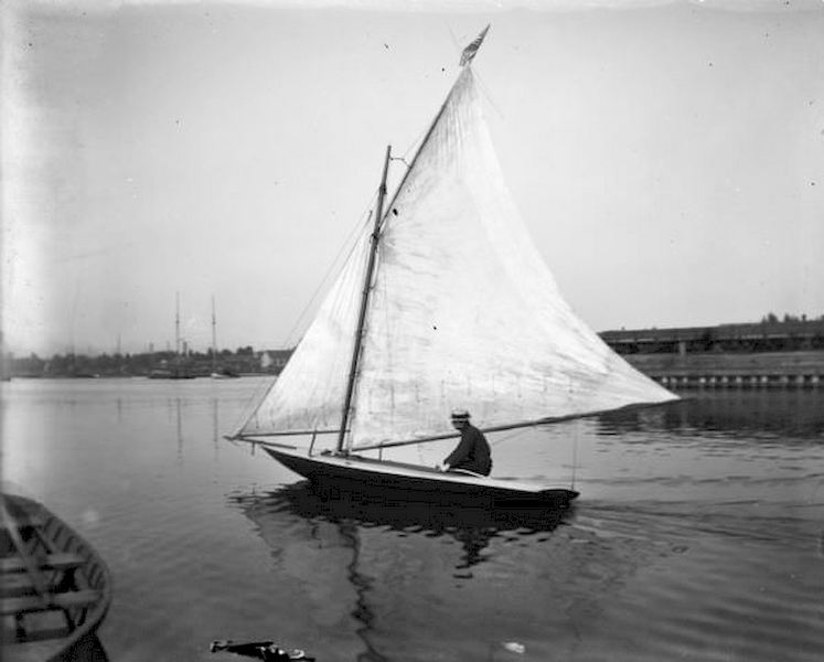 #93 Pennyfeather sitting in a small sailboat in Milwaukee Harbor, 1898