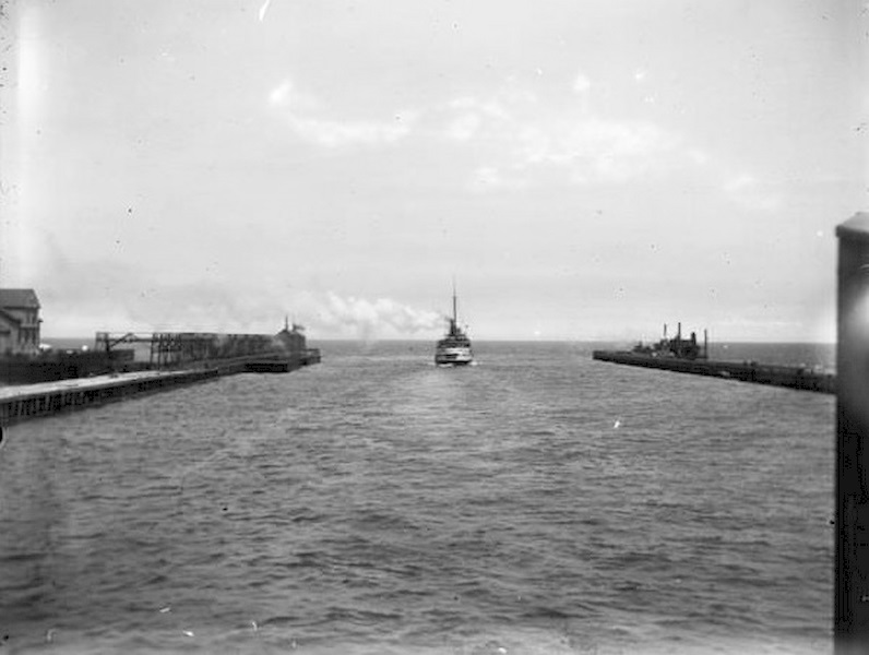 #100 A boat leaving Milwaukee Harbor between two breakwaters, steaming into Milwaukee Bay and onward out into Lake Michigan, 1899