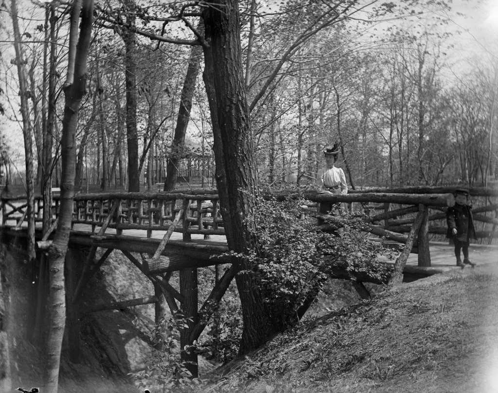 #111 Aunt Helen and Syl stand on a rustic wooden bridge in Gully Lake Park, Milwaukee, Wisconsin, May 14, 1899.