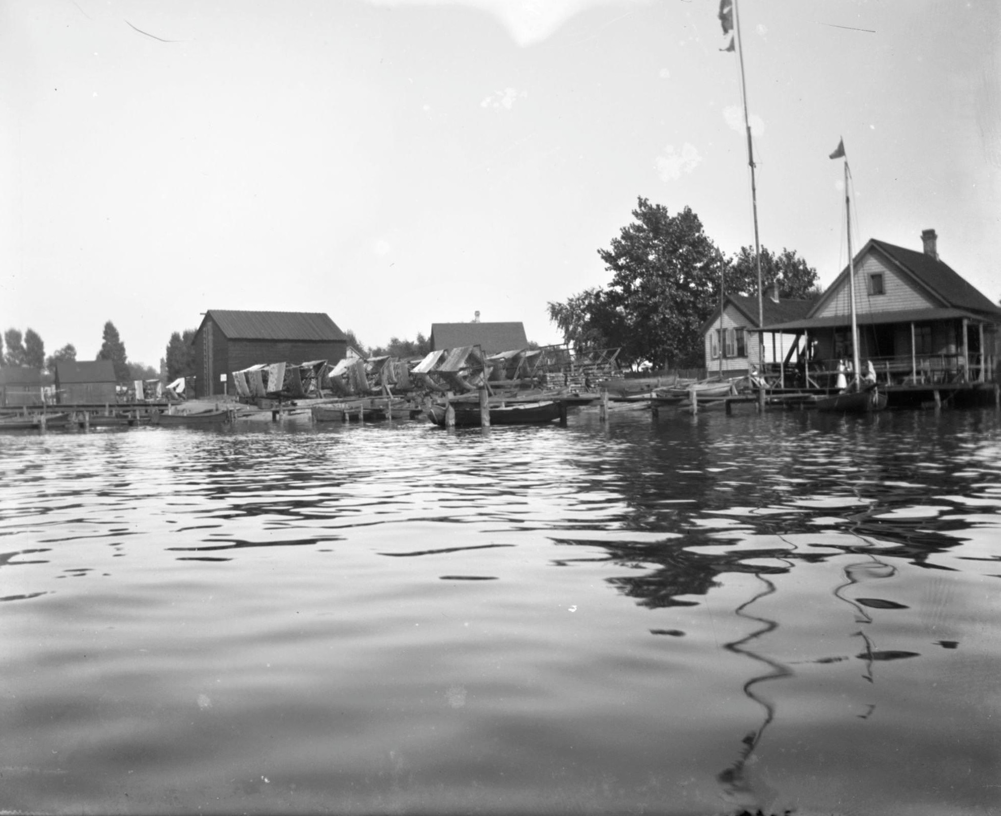 #122 View from water of boats docked near houses on Jones Island, Milwaukee, Wisconsin, 1898.