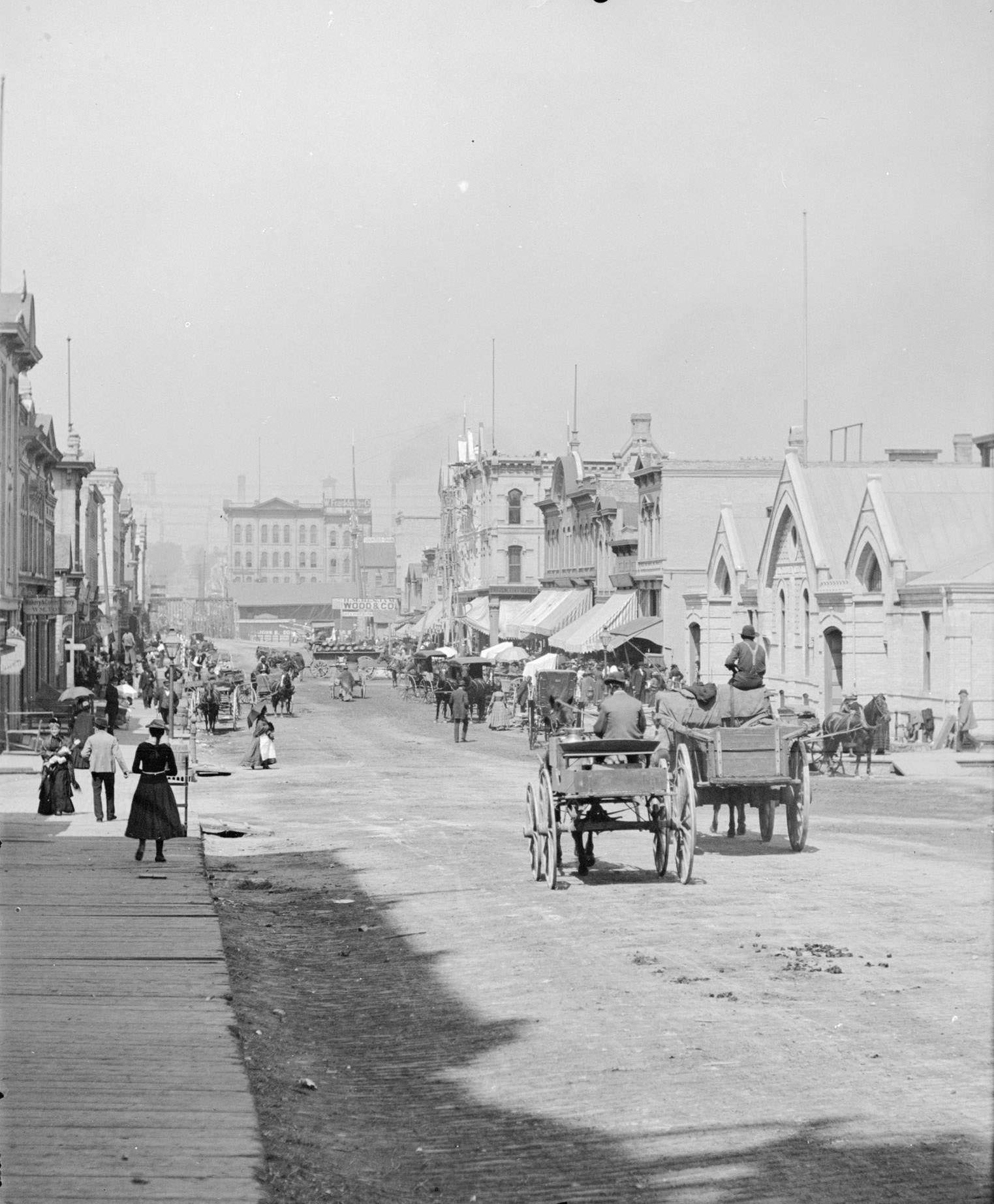 #68 German Market on the right side of the street in the distance, Milwaukee, Wisconsin, 1885.