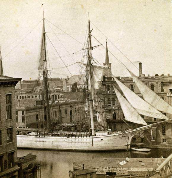 #6 Elevated view of Milwaukee River with large sailing ship – a two-masted schooner – entering the port, 1870