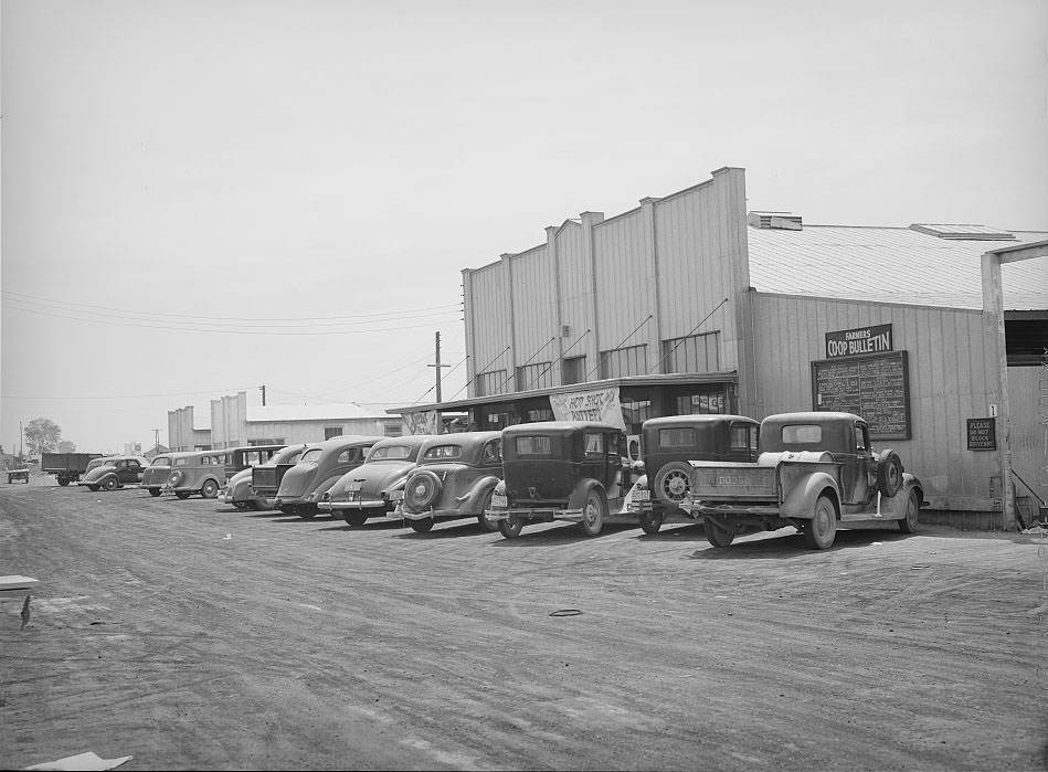 #126 Farmers’ cars in front of store and warehouse of the United Producers and Consumers Cooperative, Phoenix, Arizona, 1940
