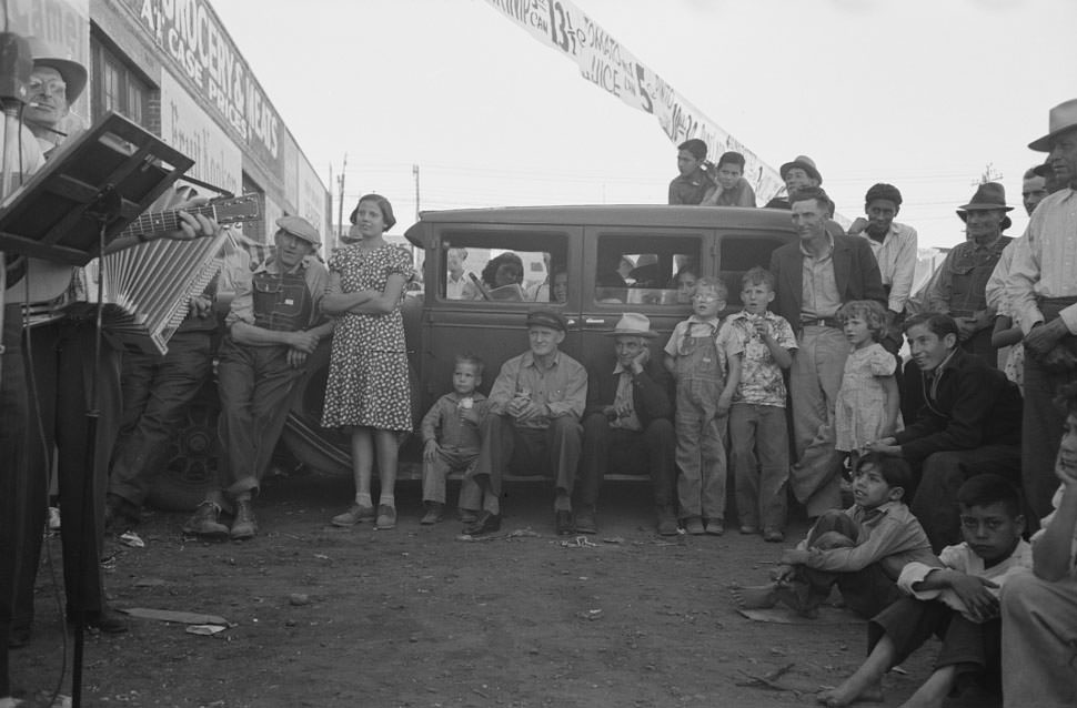 #134 Audience listening to orchestra playing outside grocery store on Saturday afternoon, Phoenix, Arizona, 1940