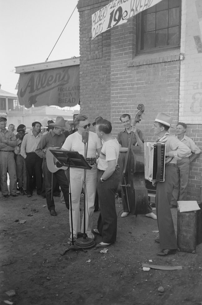 #137 Orchestra playing outside a grocery store on Saturday afternoon which is designed to attract customers to the store, Phoenix, Arizona, 1940