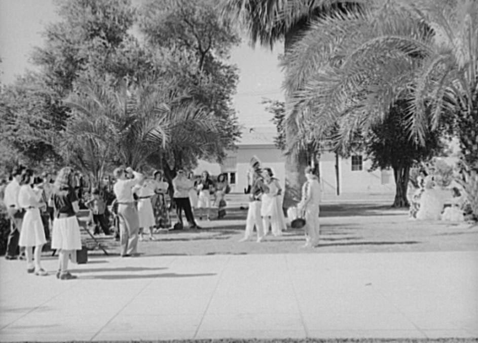 #110 High school students watching fellow classmates being photographed in their graduation play costumes, 1940