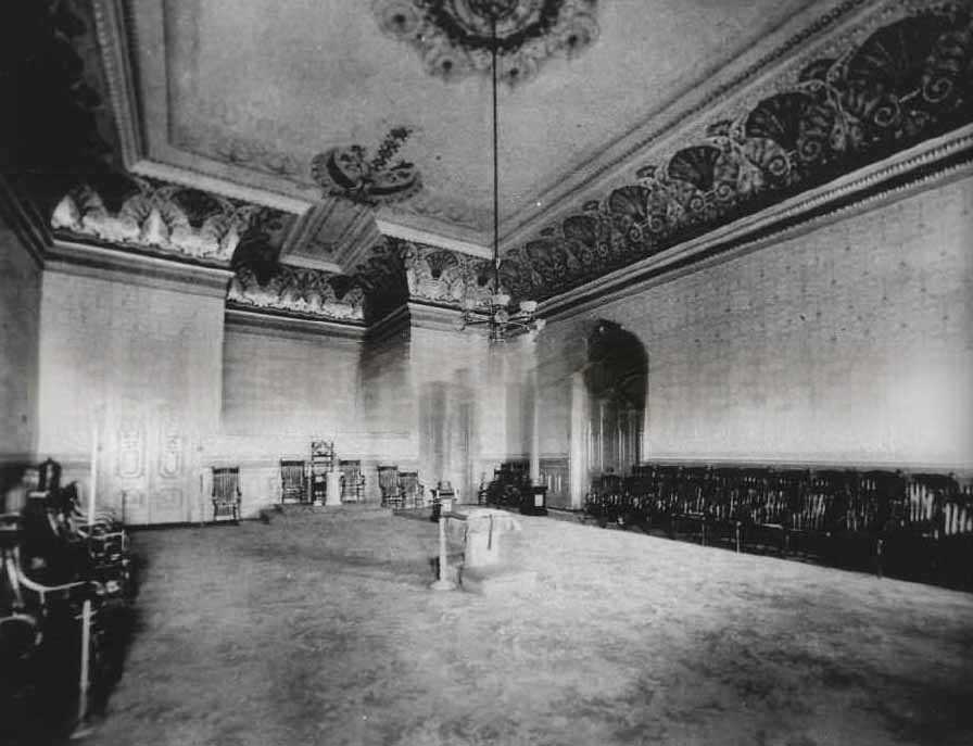 #113 The interior of what appears to be a lodge meeting room, in an unidentified location and decorated in high Victorian style, 1881