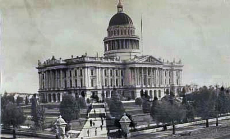 #123 View of the state capitol from 10th and L Streets; shows people walking on the sidewalk from the corner towards the capitol building, 1882