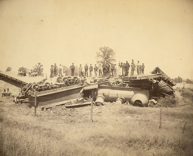 #128 View of train wreck west of Folsom, June 15, 1889 involving engine and flat cars.