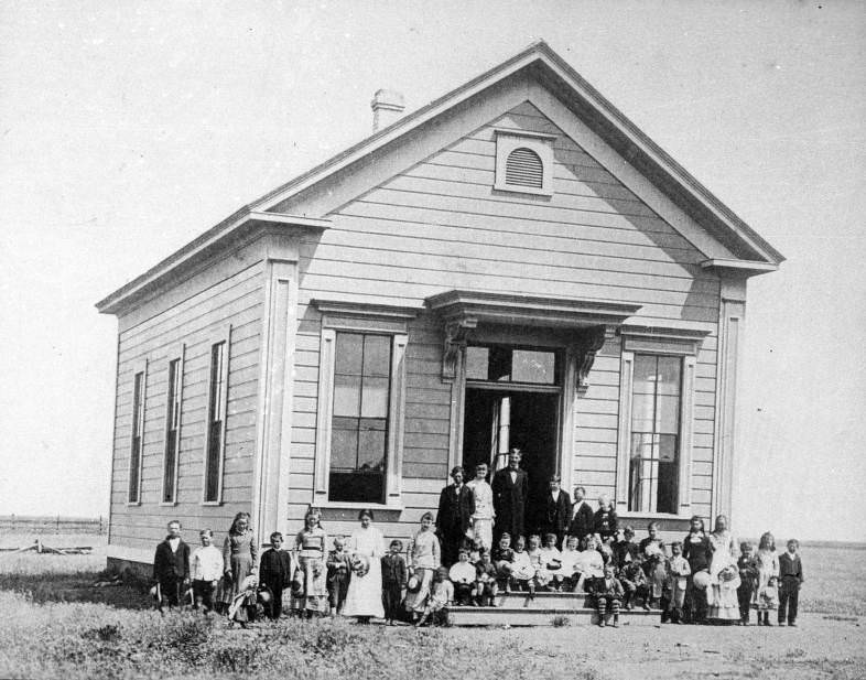 #177 View of the first school in Williams, California with school children posing outside, 1880
