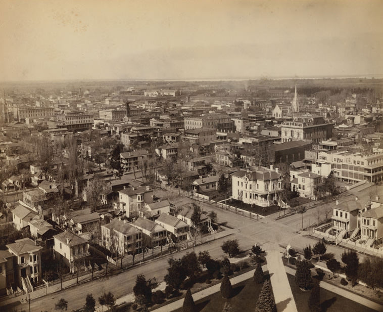 #21 Elevated view of the city looking north west from the State Capitol. Shows residents, churches, businesses, 1880